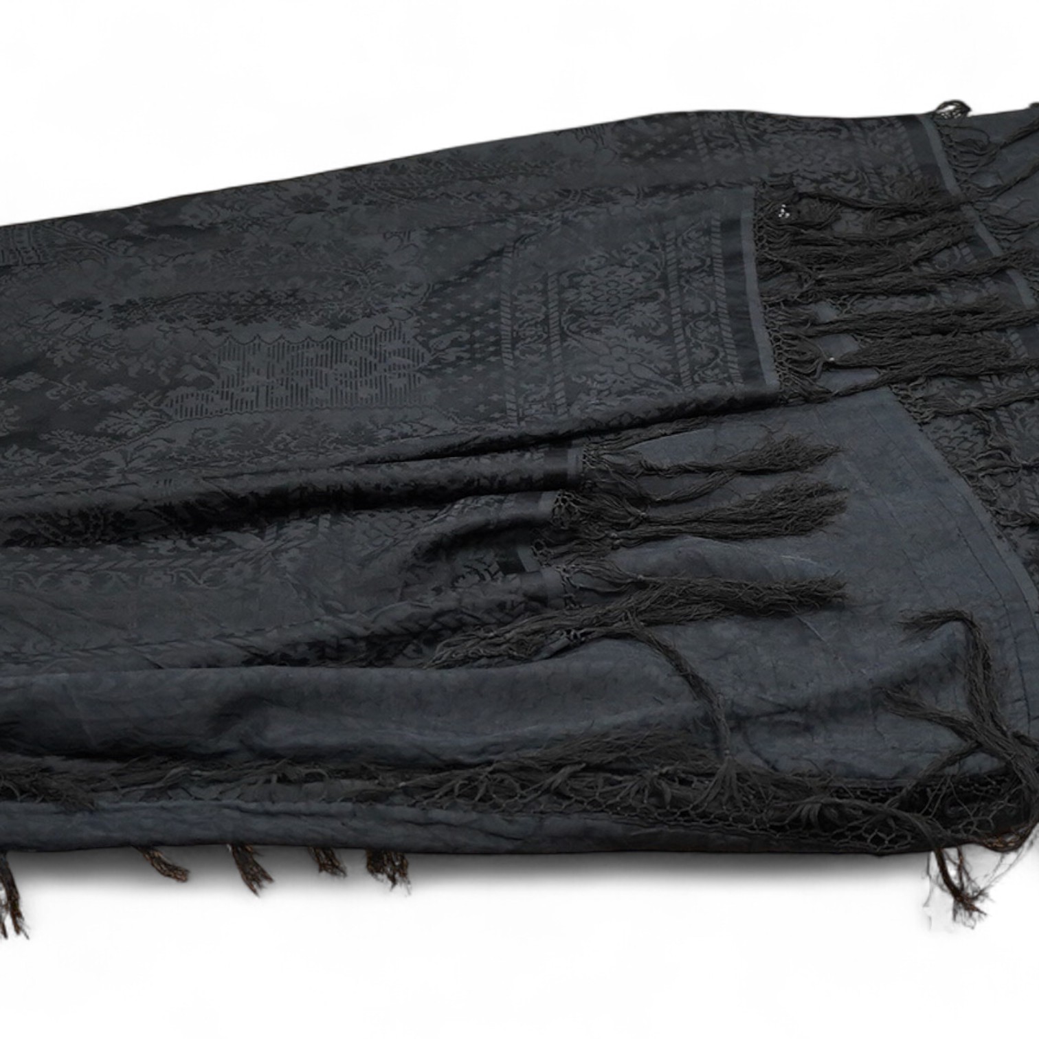 A Edwardian black silk damask paisley patterned shawl. Possibly a mourning shawl.178cm x 156cm. Condition - one small hole, otherwise good.